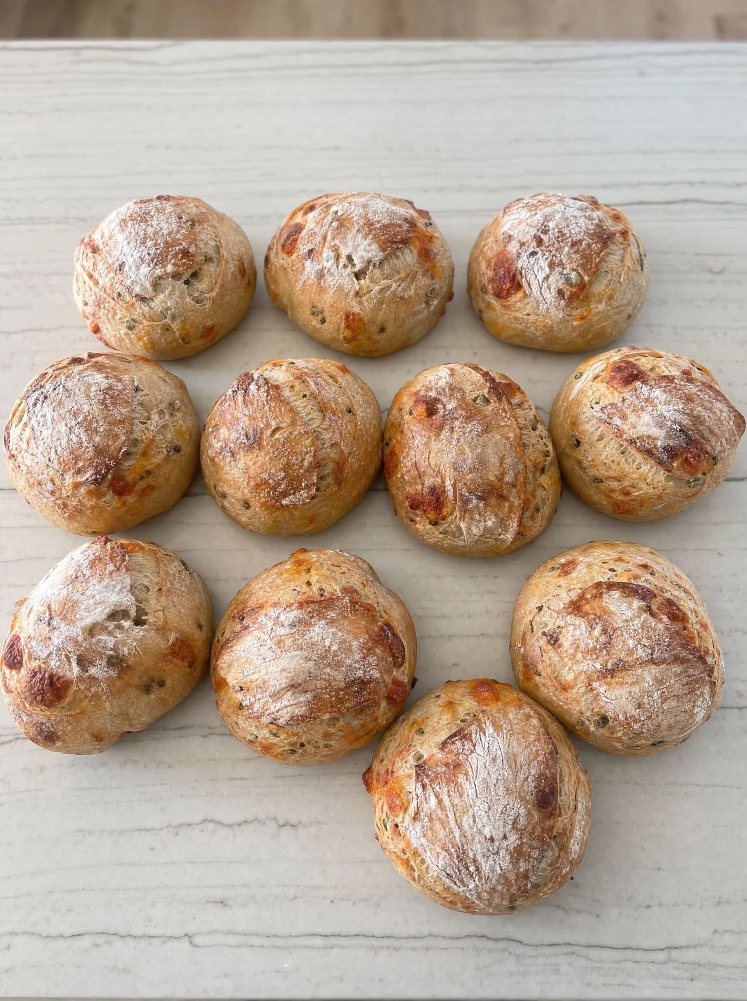 A tray of baked rolls arranged on a counter